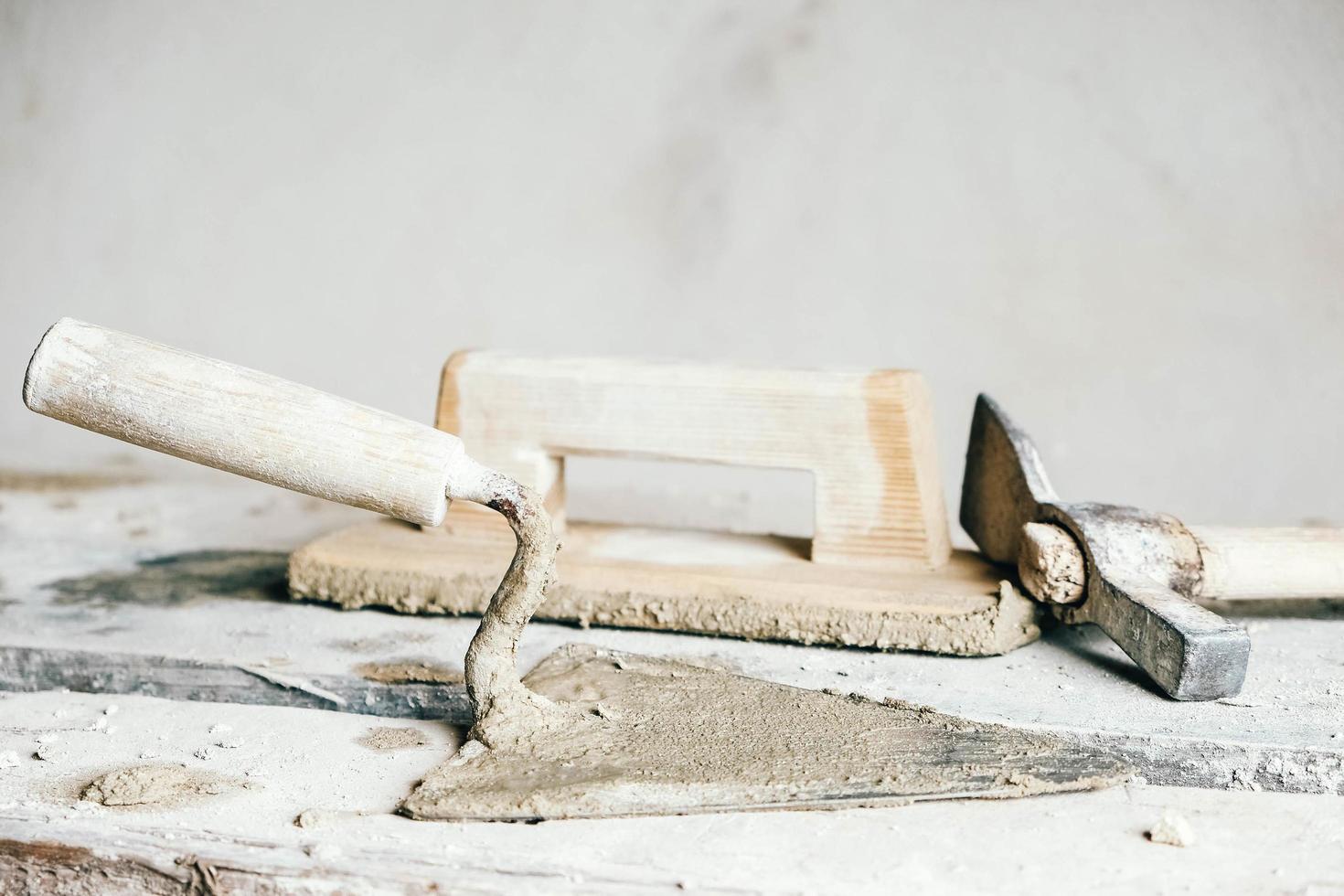 Plastering tools sale -Plastering tools sale old construction tools for plaster on vintage wood bench trowels and other masonry tools copy empty space for text free photo